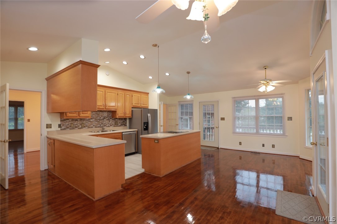 2106 Mt Blanco Road Chester, VA 23836 - Photo 13 of 50 a large kitchen with kitchen island a stove a sink a refrigerator and white cabinets with wooden floor