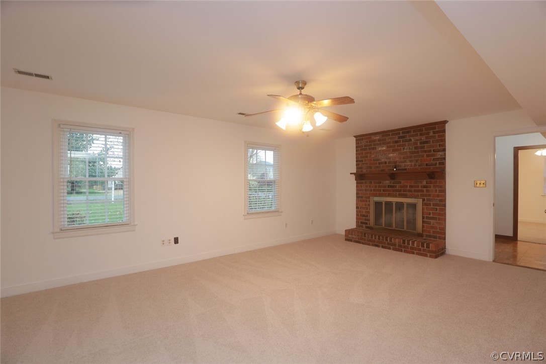 2106 Mt Blanco Road Chester, VA 23836 - Photo 20 of 50 an empty room with chandelier fan and windows
