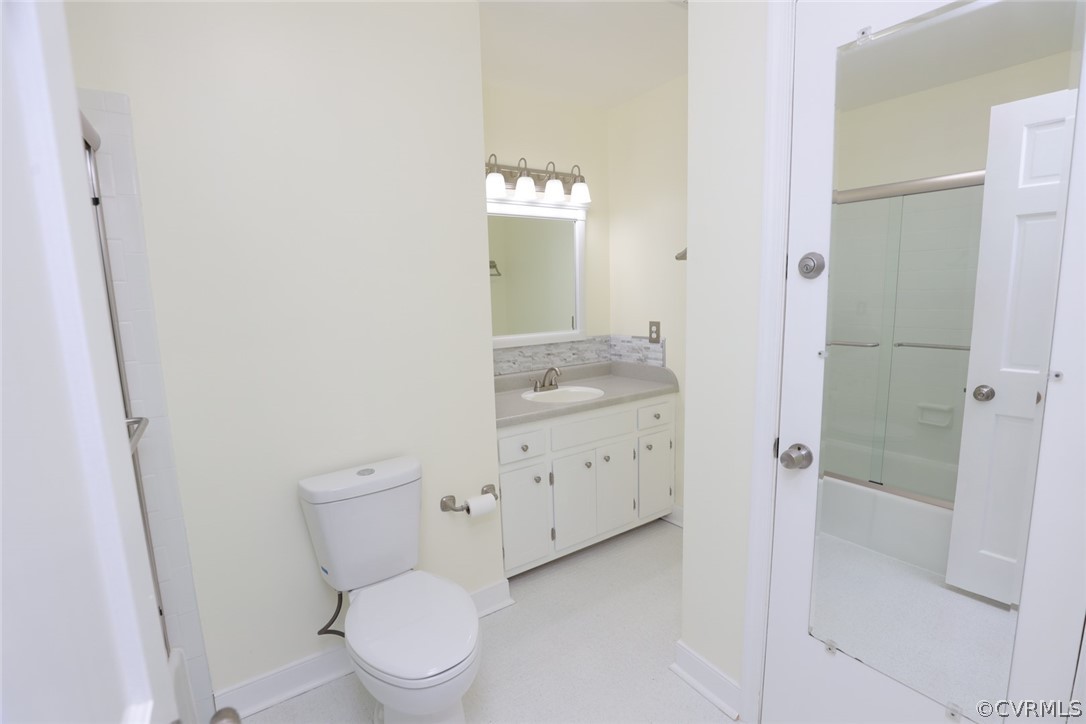 2106 Mt Blanco Road Chester, VA 23836 - Photo 24 of 50 a bathroom with a granite countertop toilet a sink and a mirror