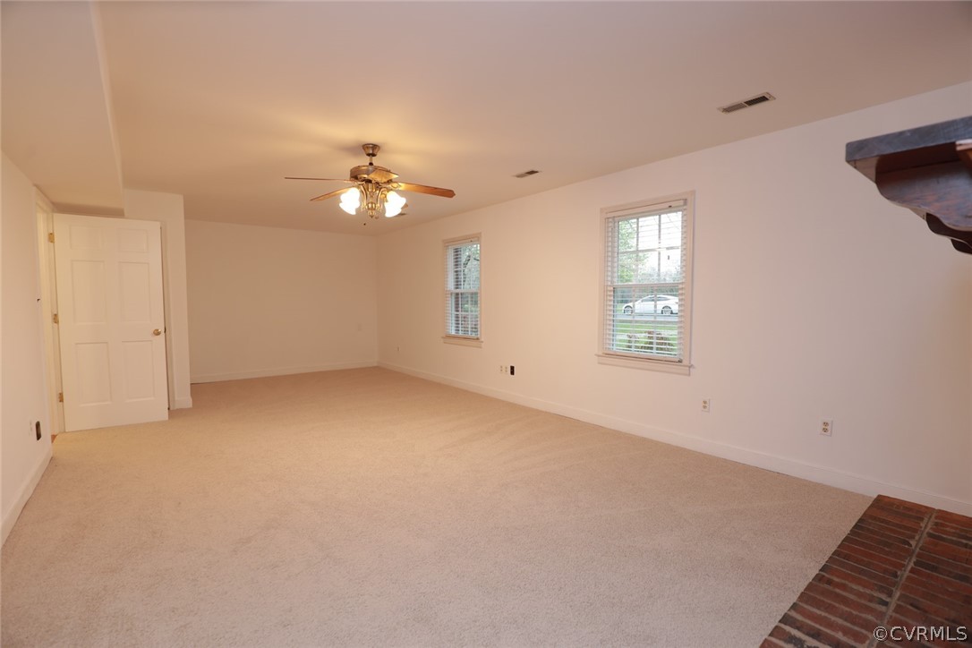 2106 Mt Blanco Road Chester, VA 23836 - Photo 27 of 50 an empty room with windows and ceiling fan