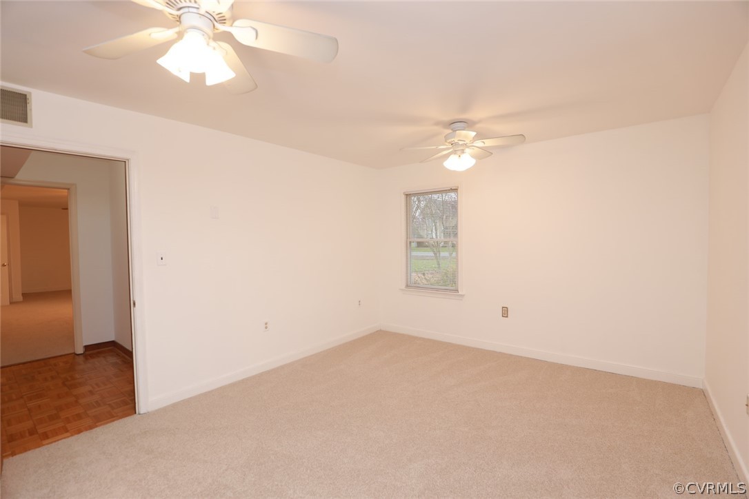 2106 Mt Blanco Road Chester, VA 23836 - Photo 31 of 50 an empty room with a chandelier fan and windows