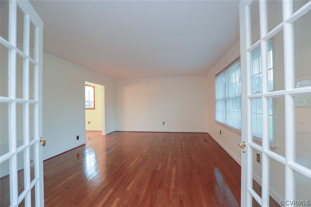 2106 Mt Blanco Road Chester, VA 23836 - Photo 6 of 50 a view of an empty room with wooden floor and windows
