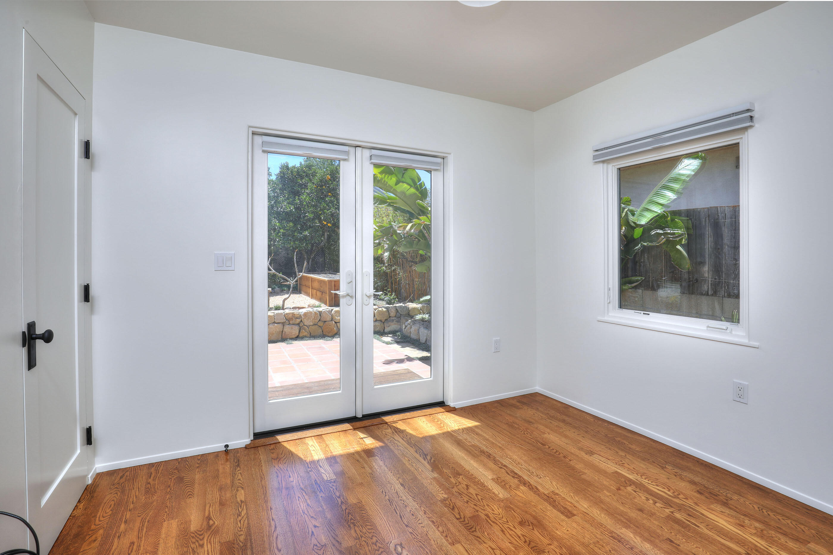 1621 Clearview Road Santa Barbara, CA 93101 - Photo 11 of 20 a view of an empty room with wooden floor and a window