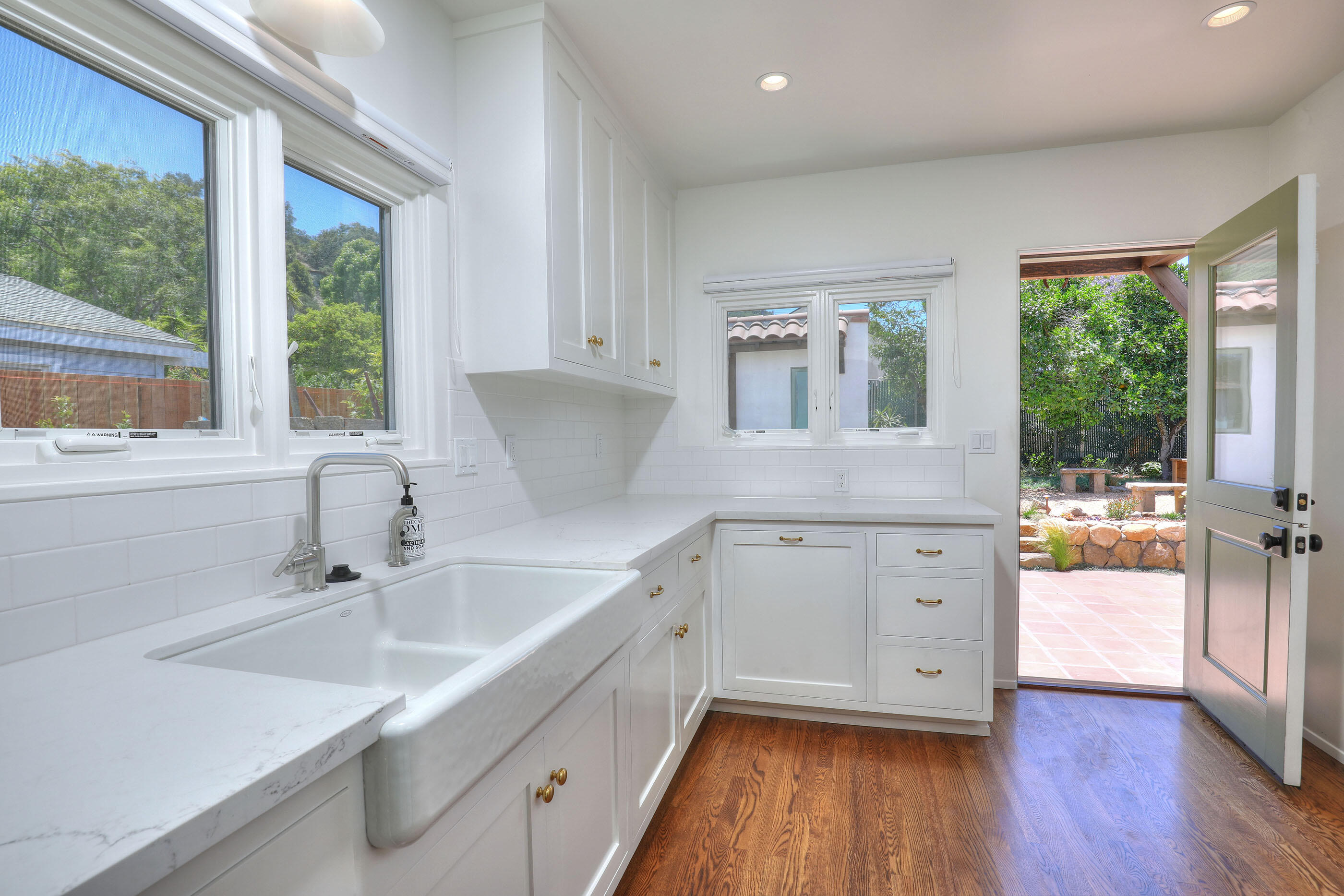 1621 Clearview Road Santa Barbara, CA 93101 - Photo 7 of 20 a kitchen with granite countertop a sink cabinets appliances and a large window