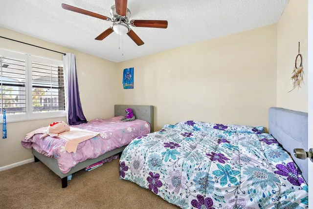 a bedroom with two beds and a chandelier