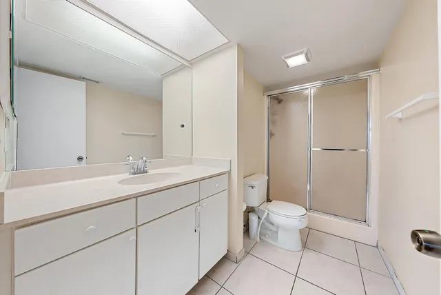 a bathroom with a double vanity sink mirror and toilet