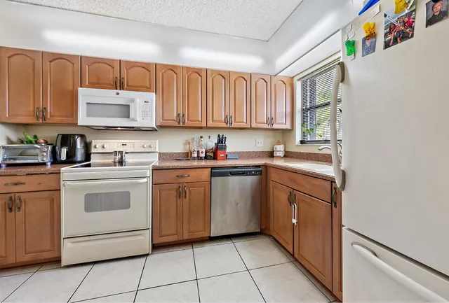 a kitchen with a white cabinets and white appliances