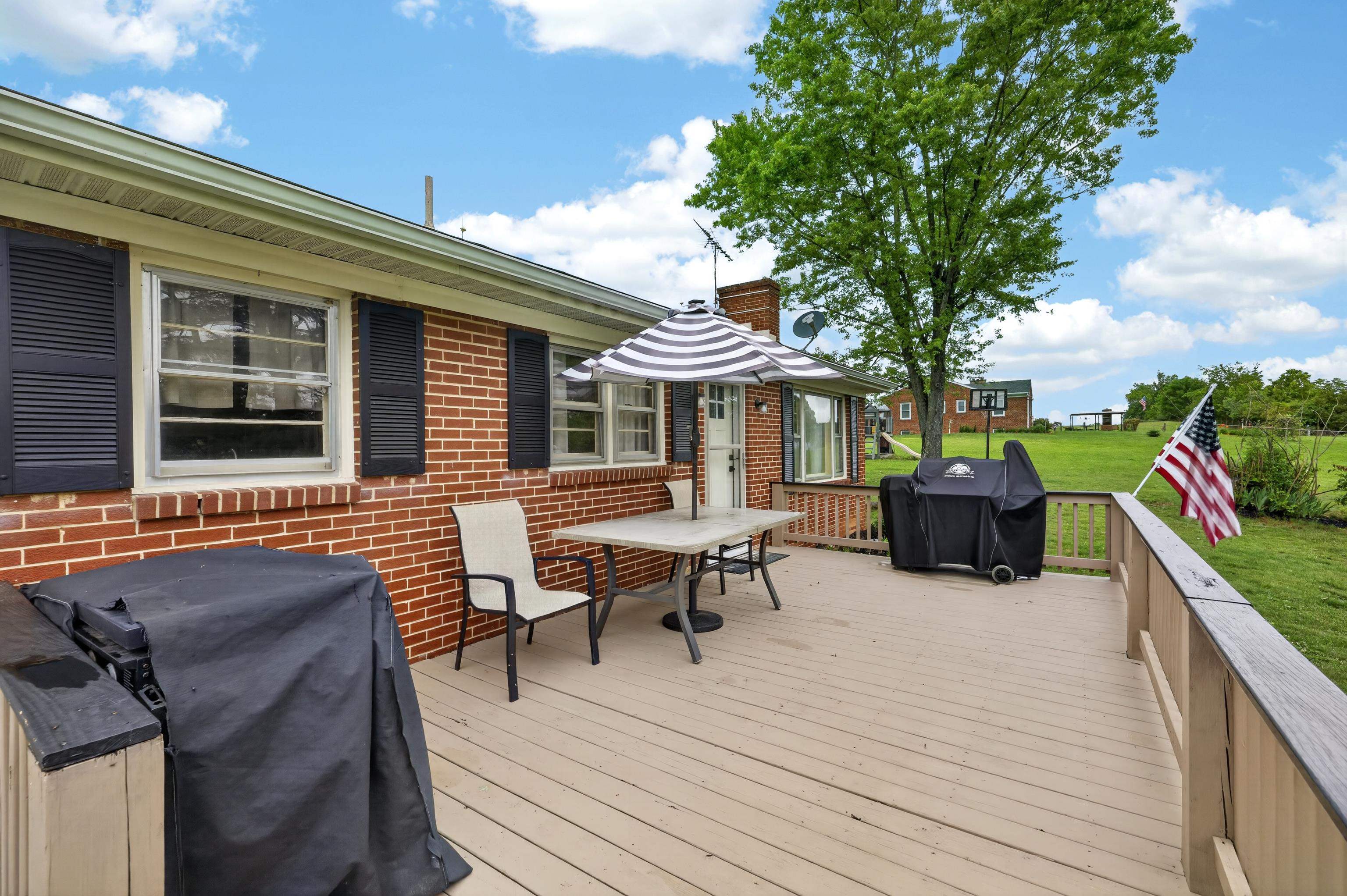 7827 Lee Highway Raphine, VA 24472 - Photo 8 of 62 a patio with wooden table and chairs