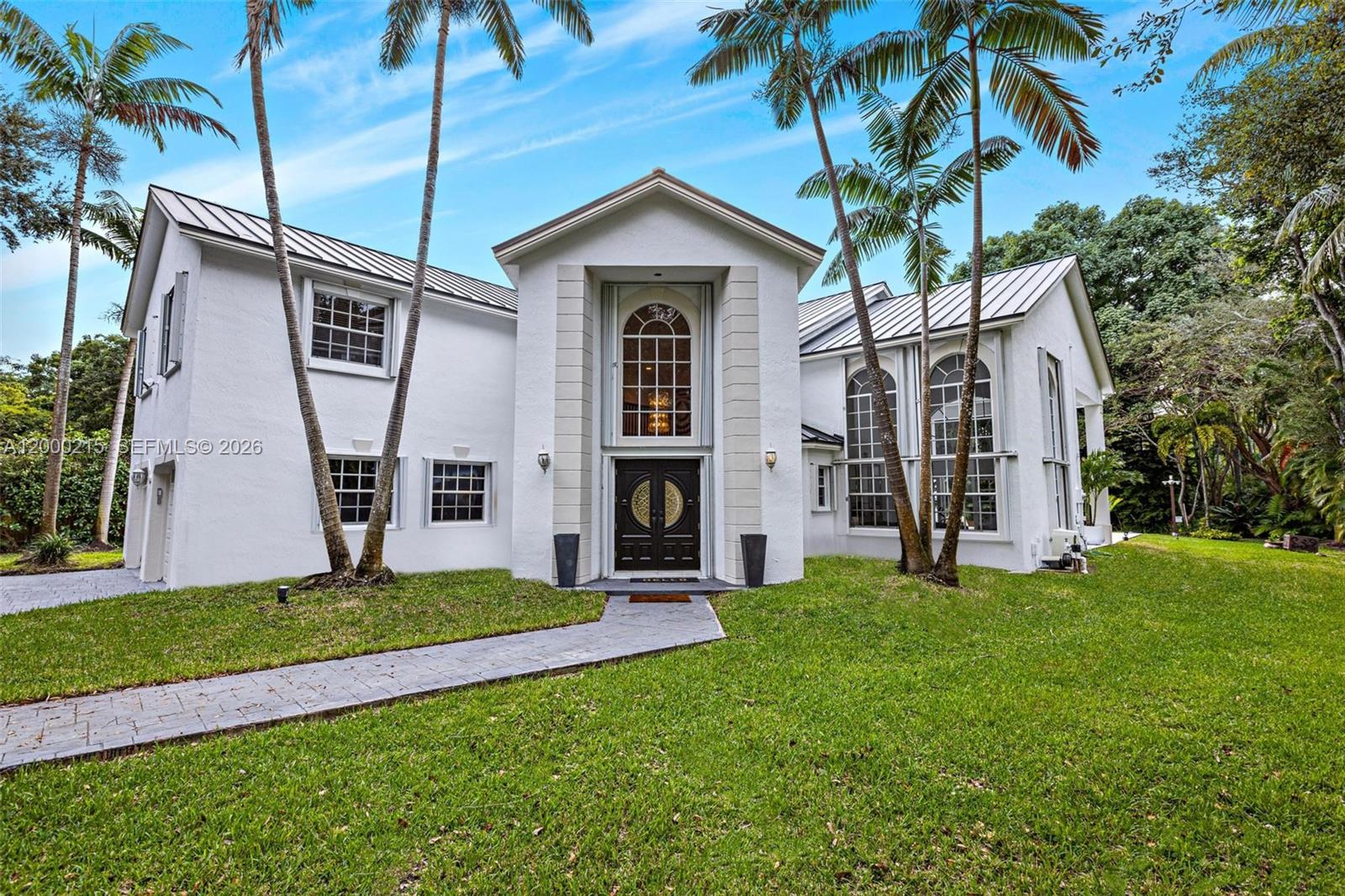 14850 Old Cutler Road Palmetto Bay, FL 33158 - Photo 1 of 19 a front view of a house with garden