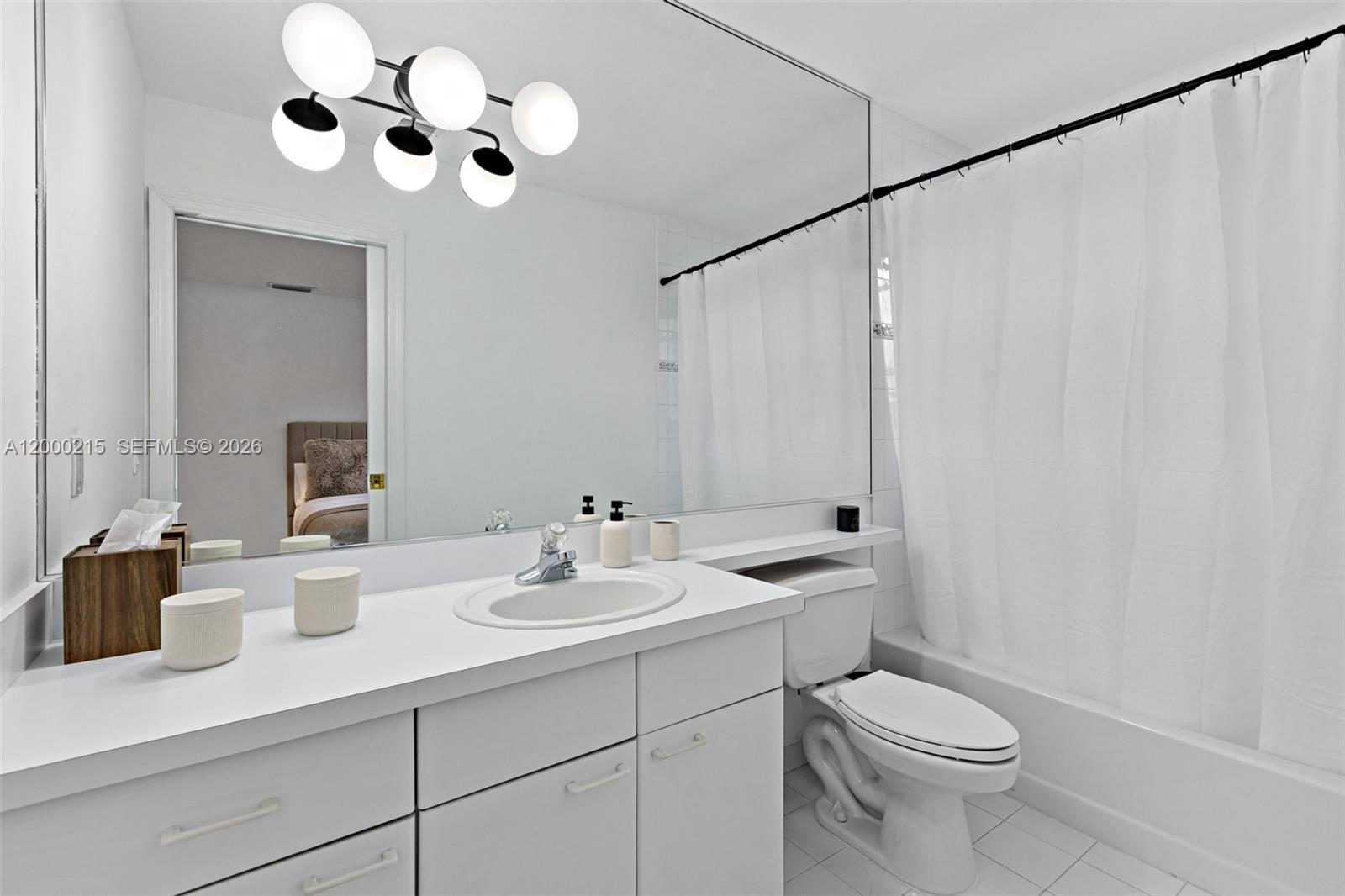 14850 Old Cutler Road Palmetto Bay, FL 33158 - Photo 15 of 19 a bathroom with a sink a toilet and a mirror