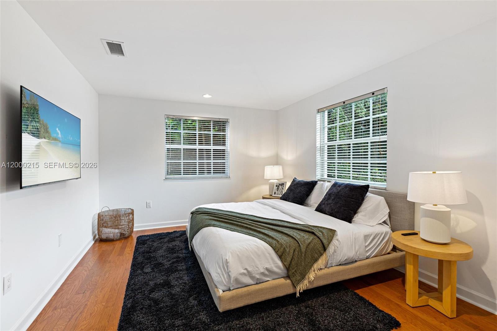 14850 Old Cutler Road Palmetto Bay, FL 33158 - Photo 16 of 19 a bedroom with a bed and wooden floor