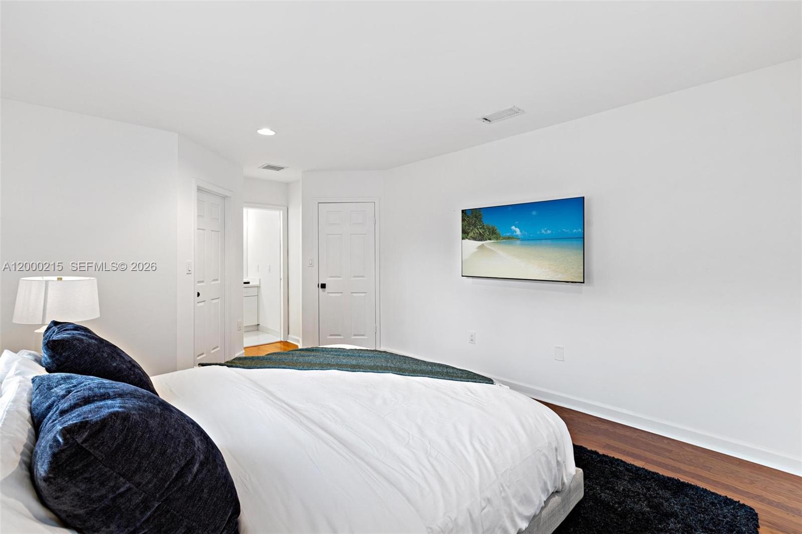 14850 Old Cutler Road Palmetto Bay, FL 33158 - Photo 17 of 19 a bedroom with a bed and a lamp