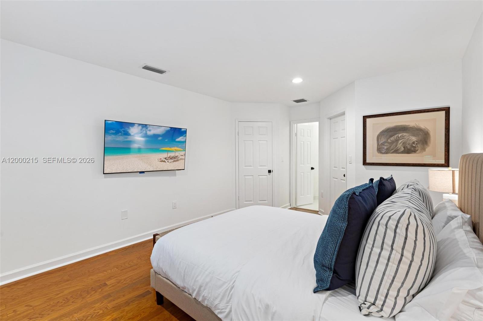 14850 Old Cutler Road Palmetto Bay, FL 33158 - Photo 18 of 19 a bedroom with a bed and painting on the wall