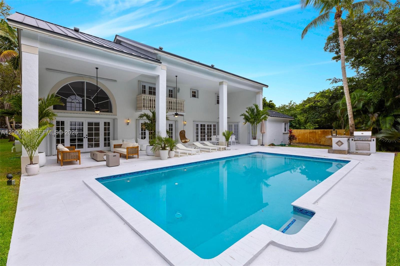 14850 Old Cutler Road Palmetto Bay, FL 33158 - Photo 3 of 19 a view of swimming pool with outdoor seating and house in the background