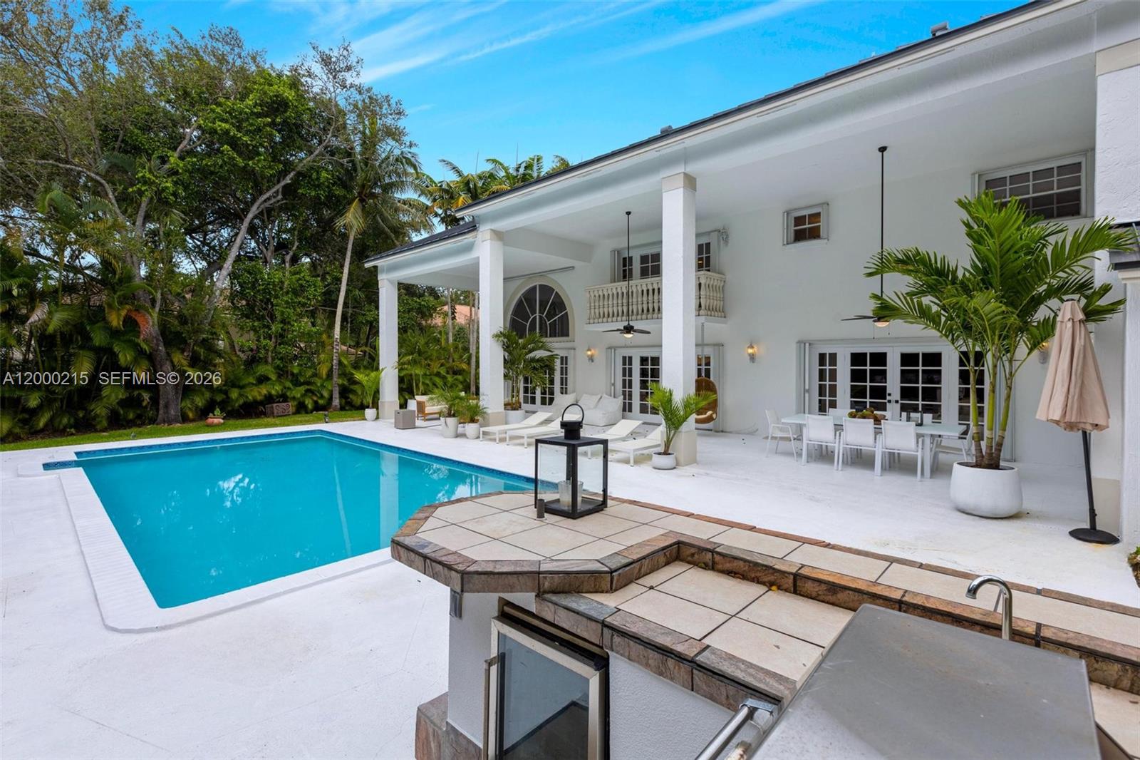 14850 Old Cutler Road Palmetto Bay, FL 33158 - Photo 4 of 19 a view of a patio with table and chairs with wooden floor and fence