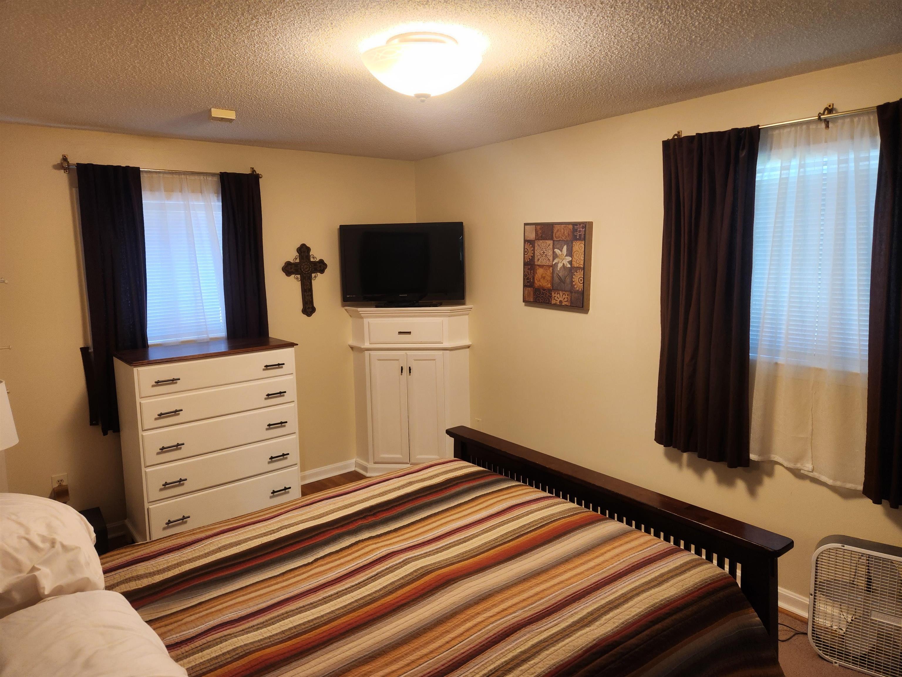 1424 Mullins Station Road Memphis, TN 38134 - Photo 14 of 40 a room with furniture and flat screen tv