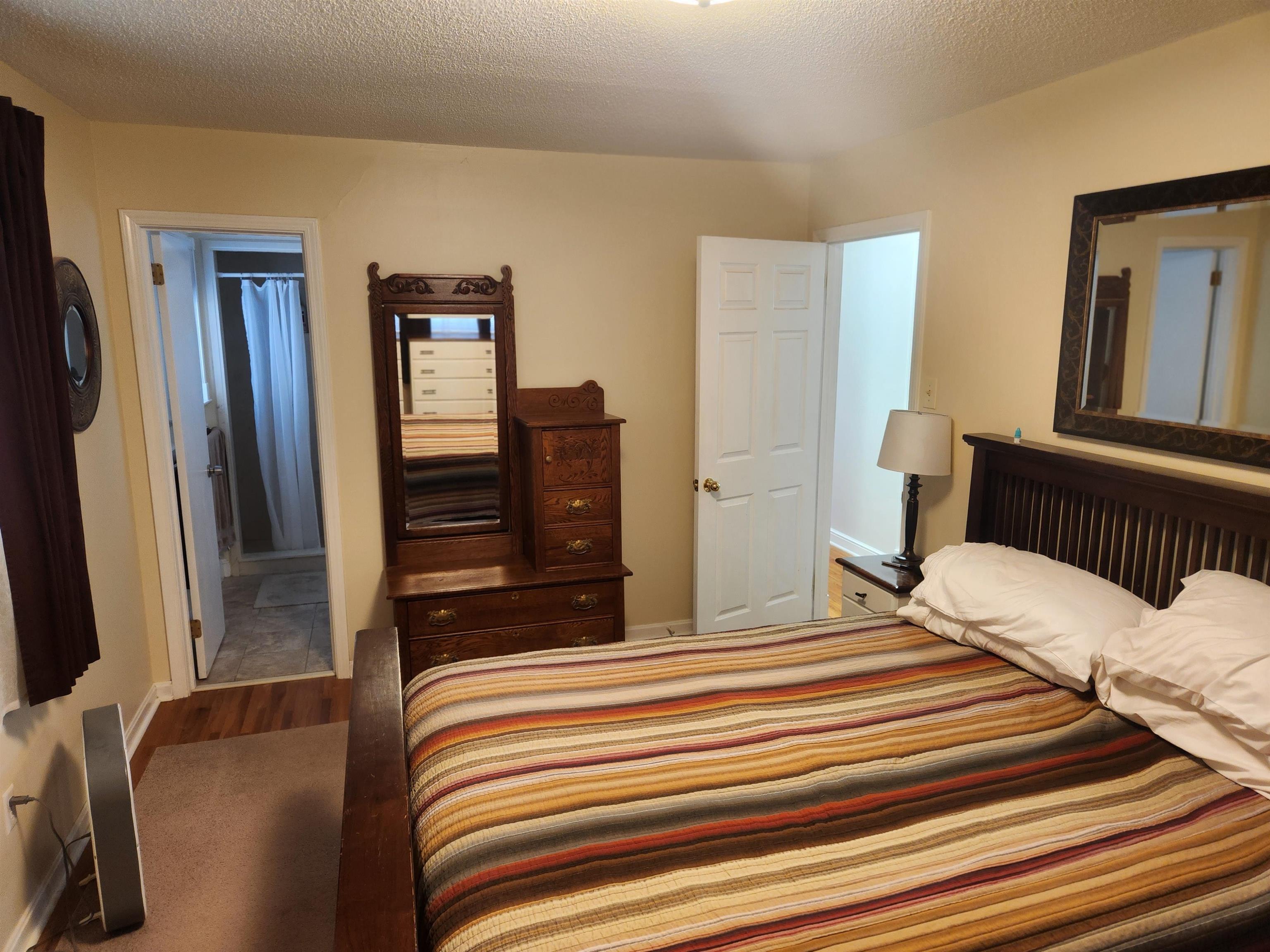 1424 Mullins Station Road Memphis, TN 38134 - Photo 15 of 40 a bedroom with a bed and a dresser