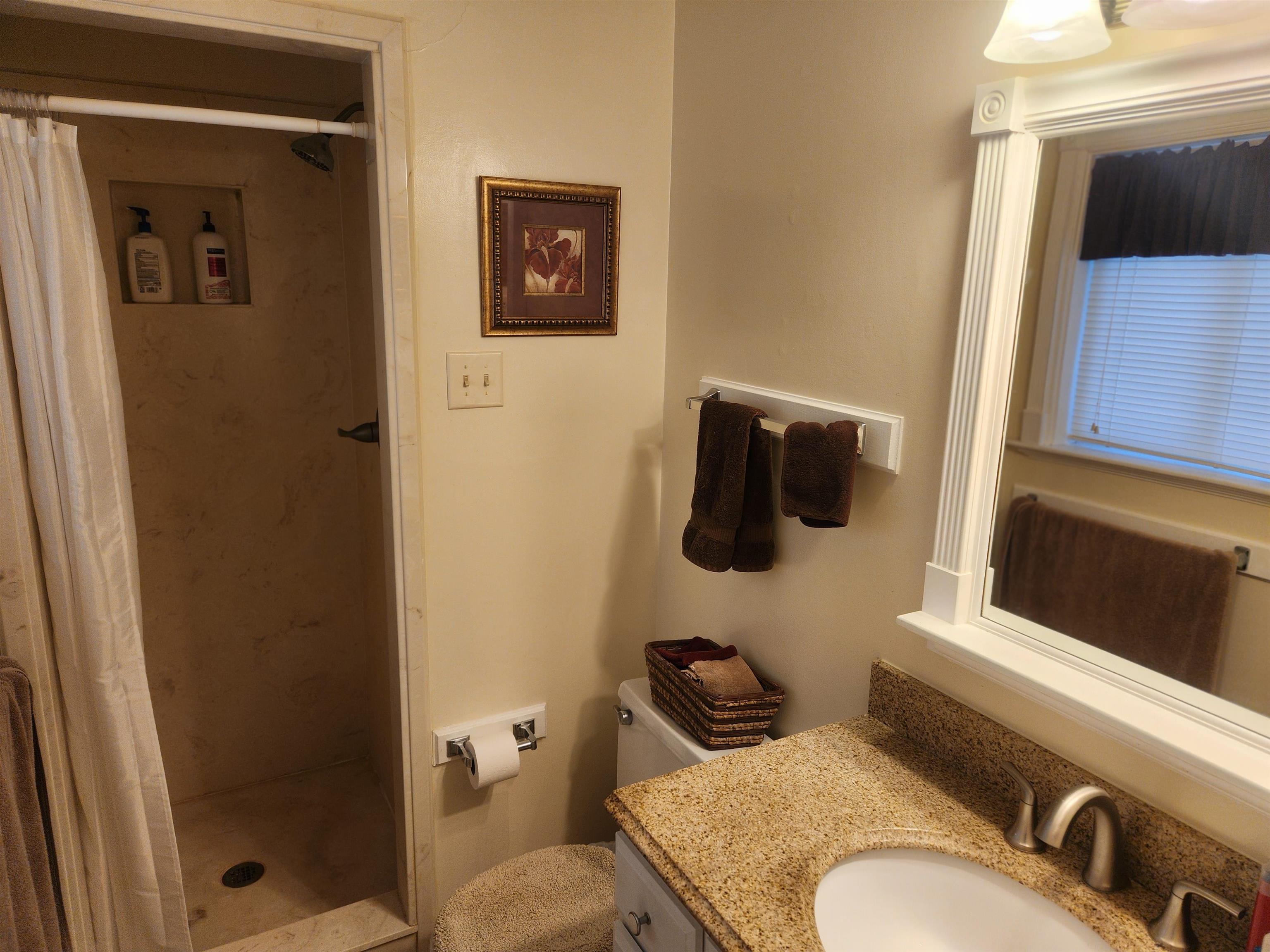 1424 Mullins Station Road Memphis, TN 38134 - Photo 16 of 40 a bathroom with a sink and a mirror