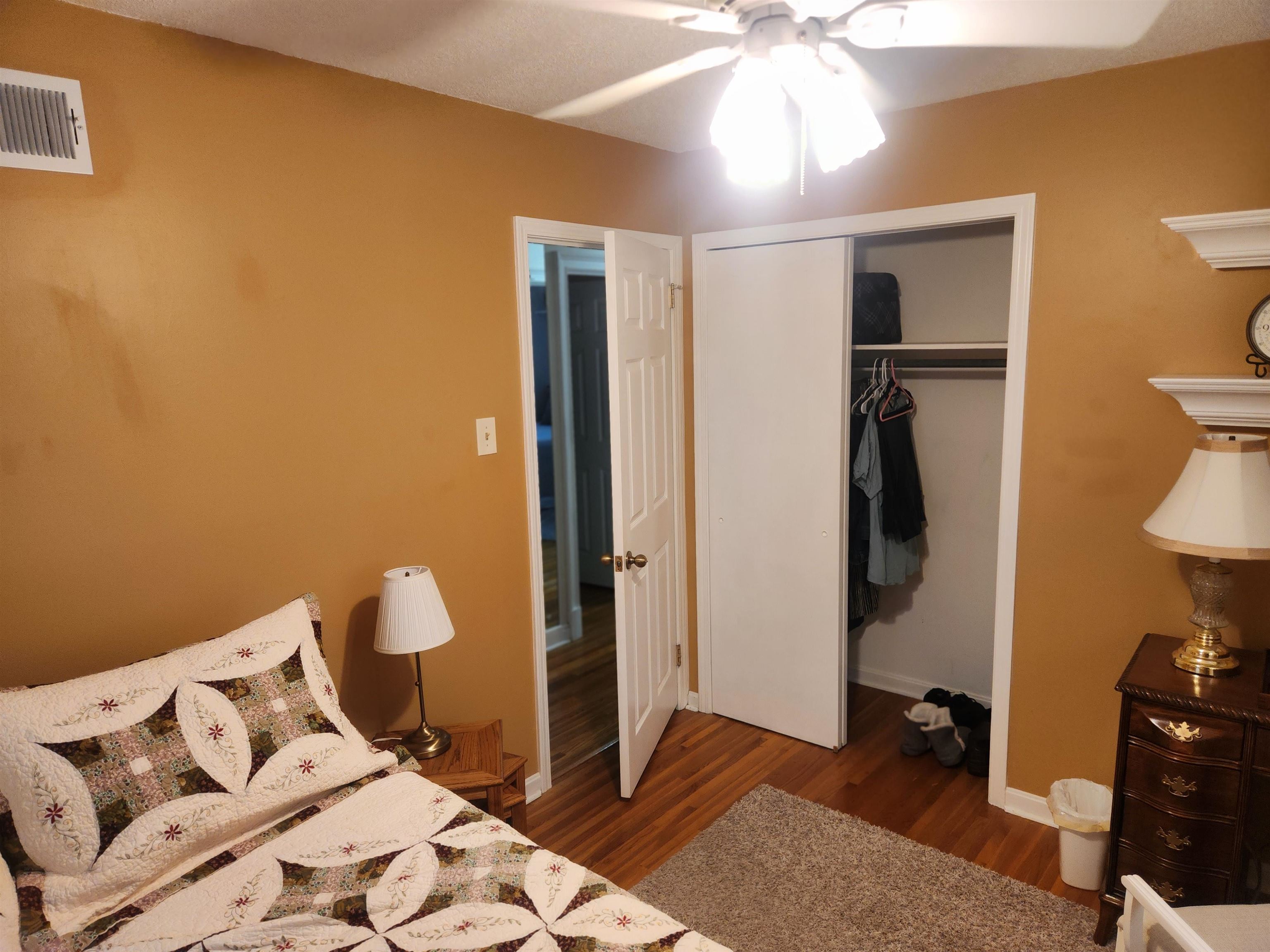 1424 Mullins Station Road Memphis, TN 38134 - Photo 17 of 40 a bedroom with a bed and a chandelier