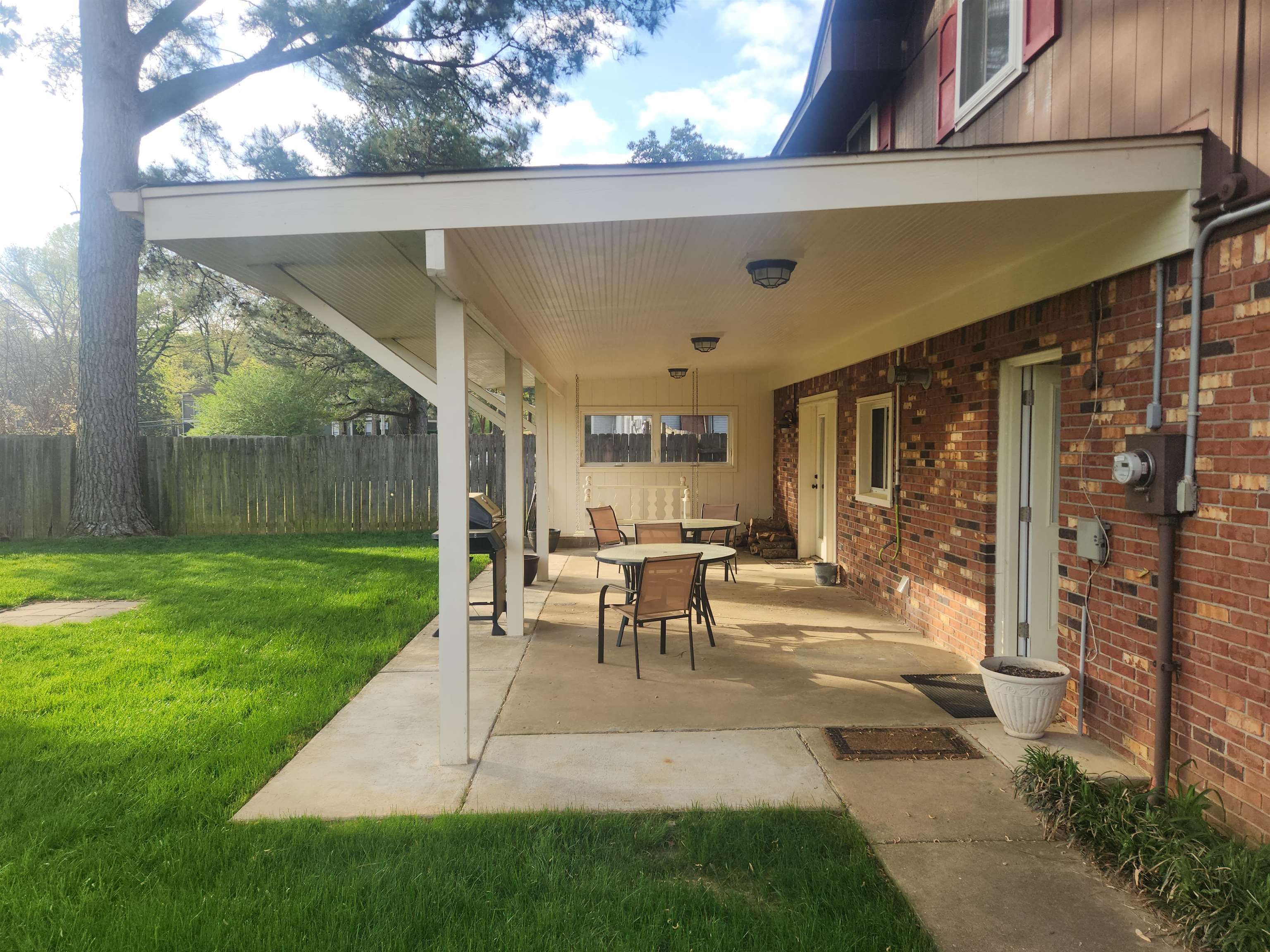 1424 Mullins Station Road Memphis, TN 38134 - Photo 38 of 40 a view of a patio with table and chairs potted plants with wooden floor