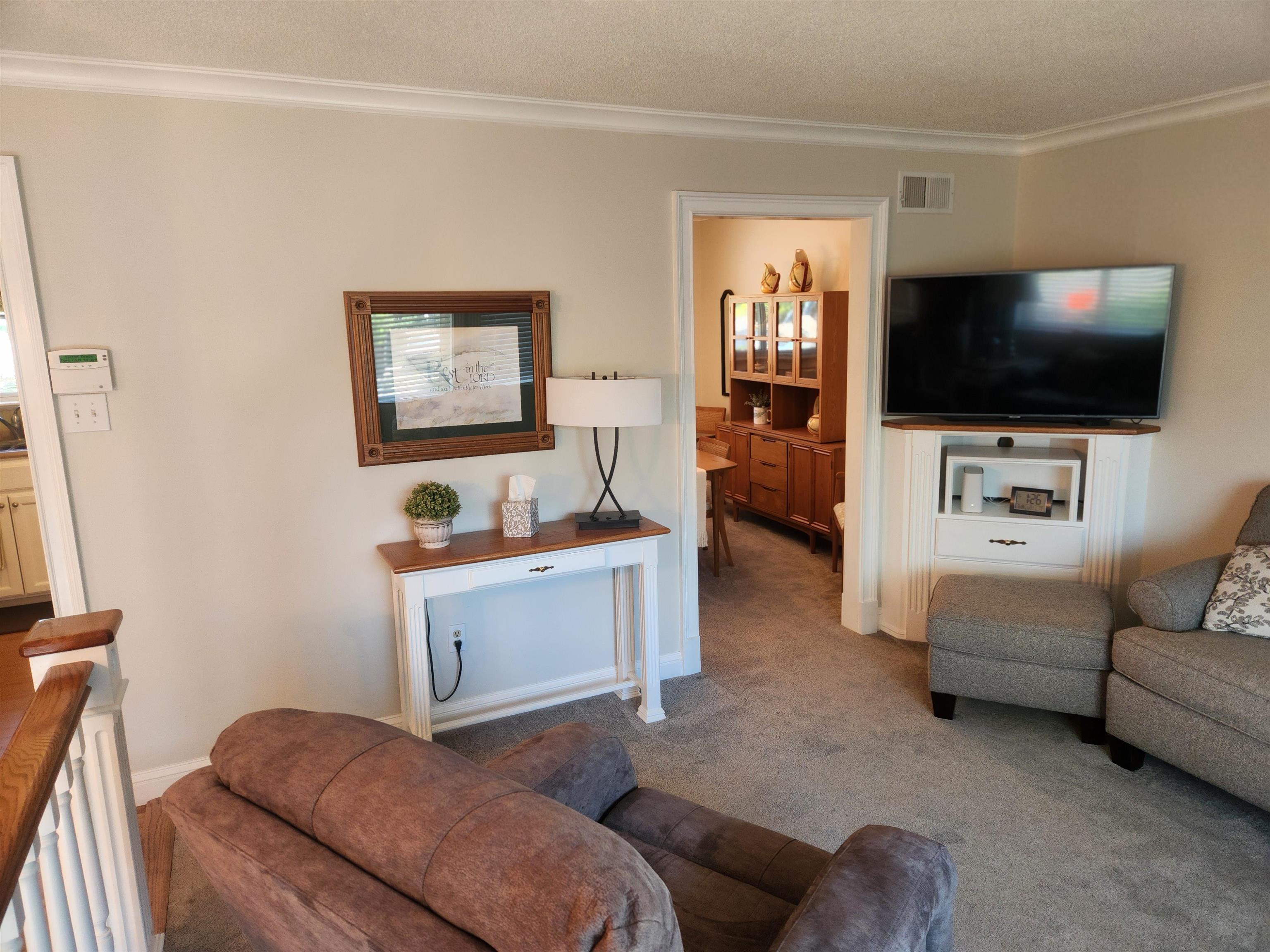 1424 Mullins Station Road Memphis, TN 38134 - Photo 8 of 40 a living room with furniture and a flat screen tv