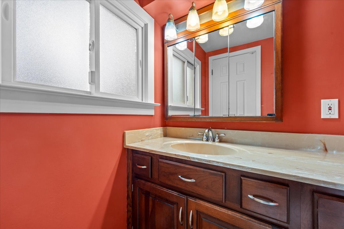 1115 Kenton Road Deerfield, IL 60015 - Photo 13 of 30 a bathroom with a sink and a mirror