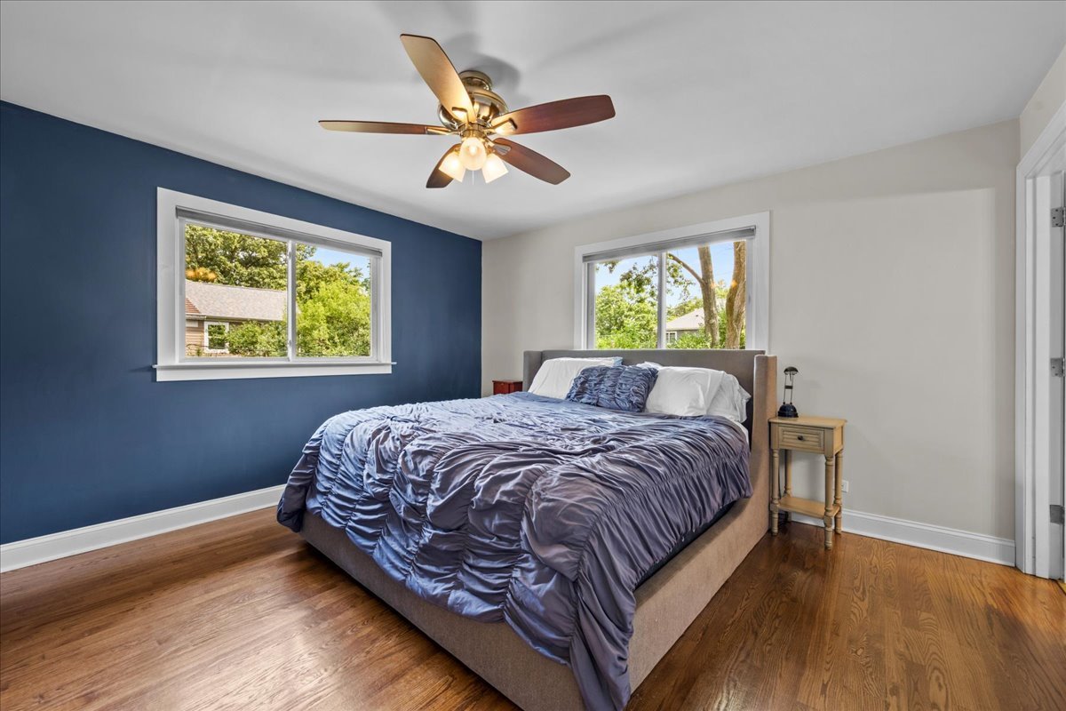 1115 Kenton Road Deerfield, IL 60015 - Photo 14 of 30 a bedroom with a bed and a chandelier