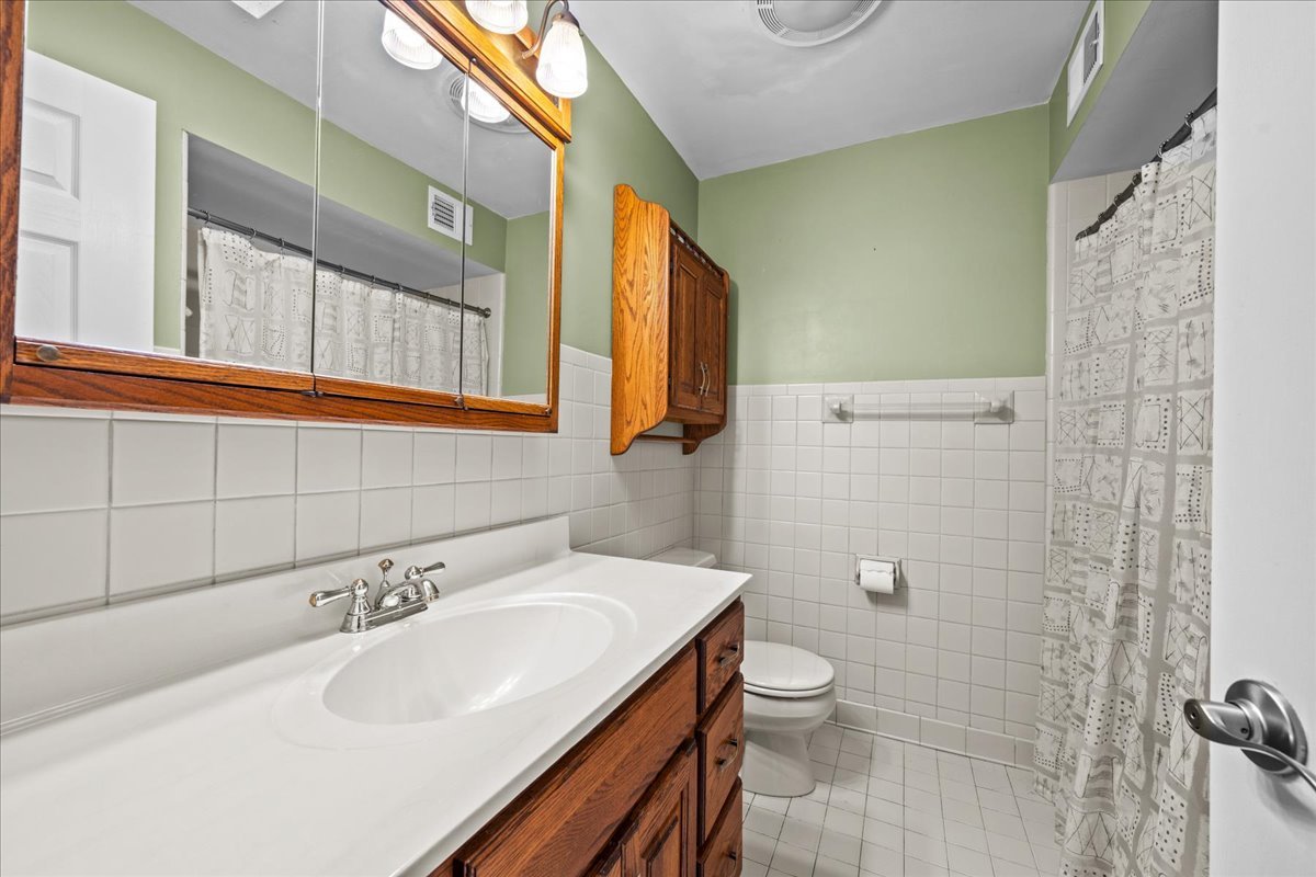 1115 Kenton Road Deerfield, IL 60015 - Photo 20 of 30 a bathroom with a sink a toilet and shower