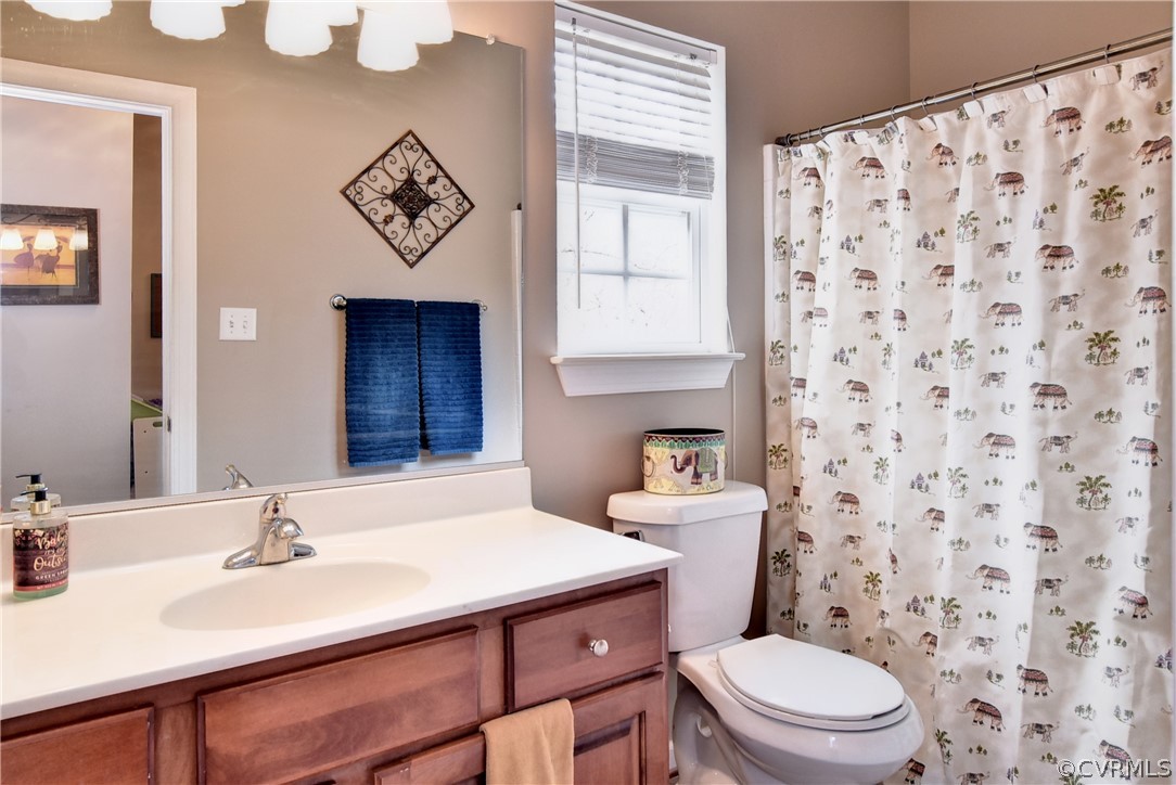 3986 Bournemouth Bend Williamsburg, VA 23188 - Photo 13 of 47 a bathroom with a sink a toilet and shower curtain