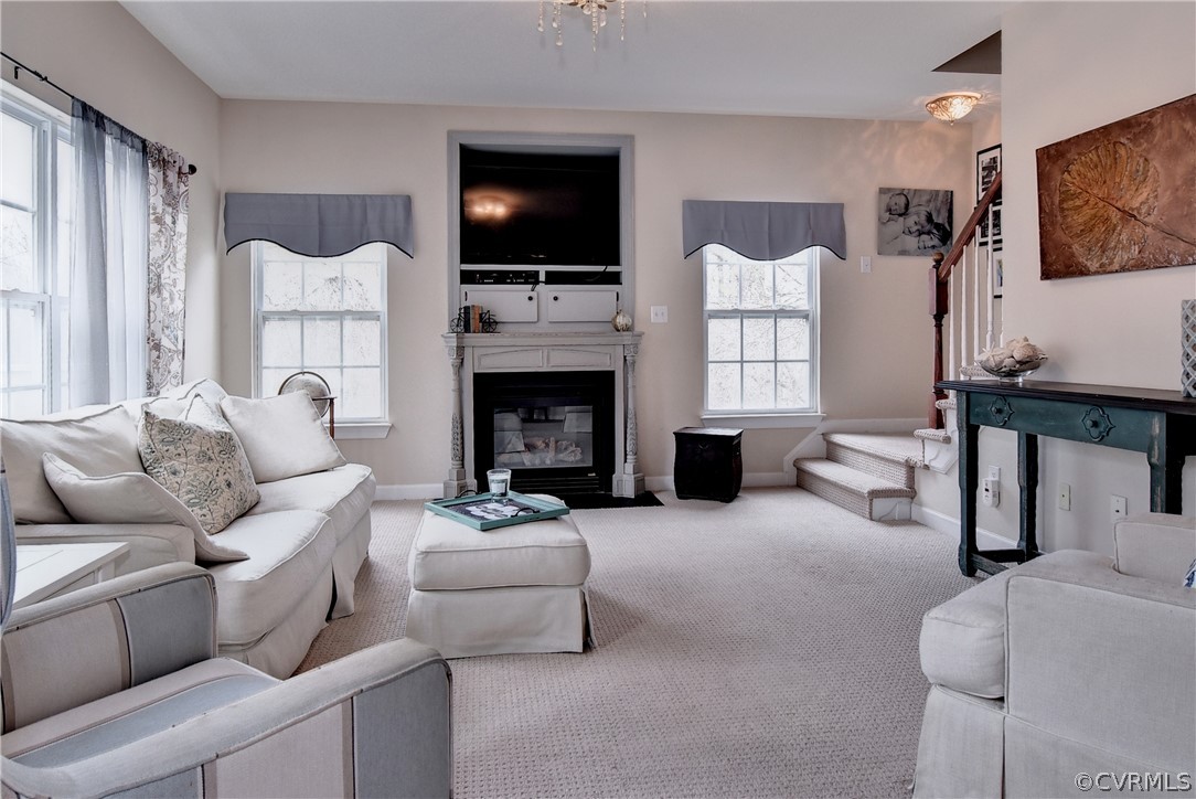 3986 Bournemouth Bend Williamsburg, VA 23188 - Photo 14 of 47 a living room with furniture a flat screen tv and a fireplace