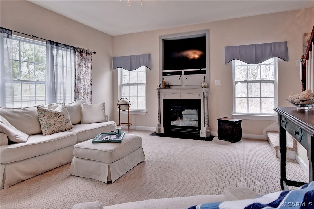 3986 Bournemouth Bend Williamsburg, VA 23188 - Photo 15 of 47 a living room with furniture a flat screen tv and a fireplace