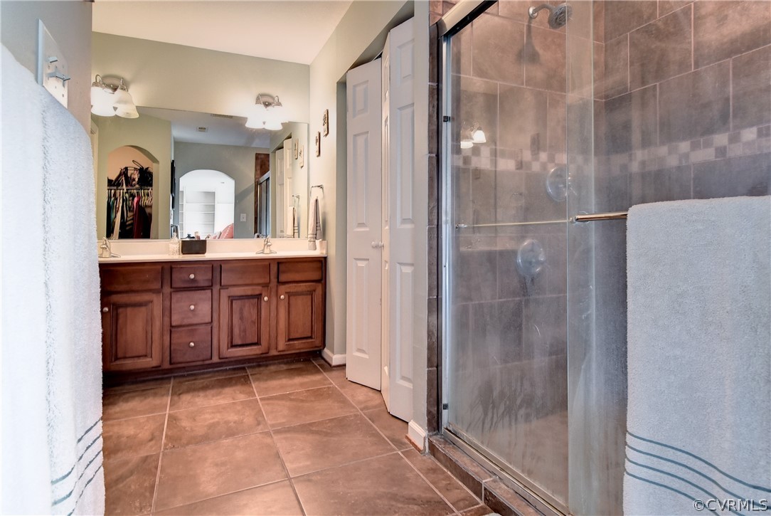 3986 Bournemouth Bend Williamsburg, VA 23188 - Photo 20 of 47 a bathroom with a sink a mirror and a shower