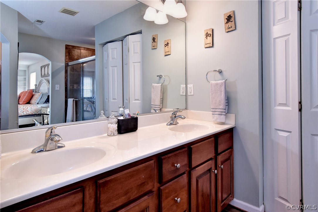 3986 Bournemouth Bend Williamsburg, VA 23188 - Photo 21 of 47 a bathroom with a double vanity sink and a mirror