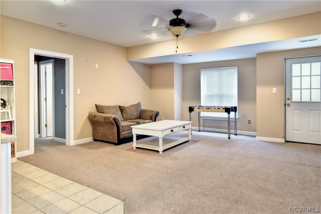 3986 Bournemouth Bend Williamsburg, VA 23188 - Photo 33 of 47 a living room with furniture and a chandelier