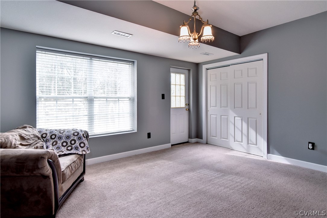 3986 Bournemouth Bend Williamsburg, VA 23188 - Photo 36 of 47 a spacious bedroom with a bed and a chandelier