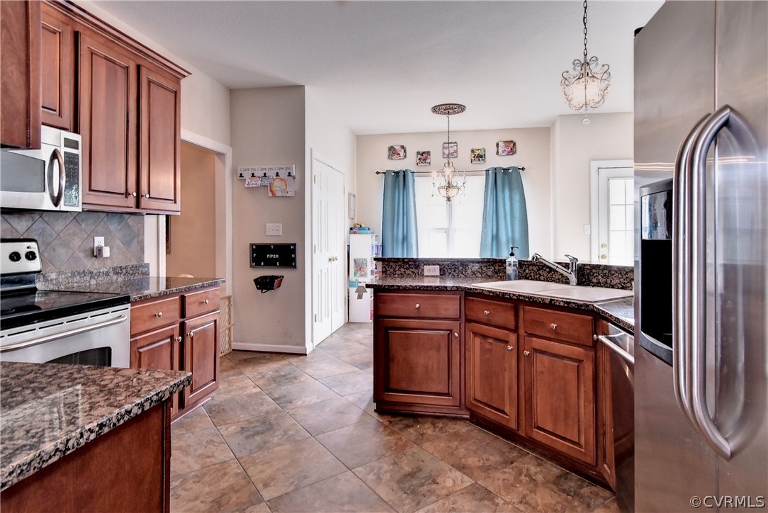 3986 Bournemouth Bend Williamsburg, VA 23188 - Photo 7 of 47 a large kitchen with stainless steel appliances granite countertop a refrigerator and a sink