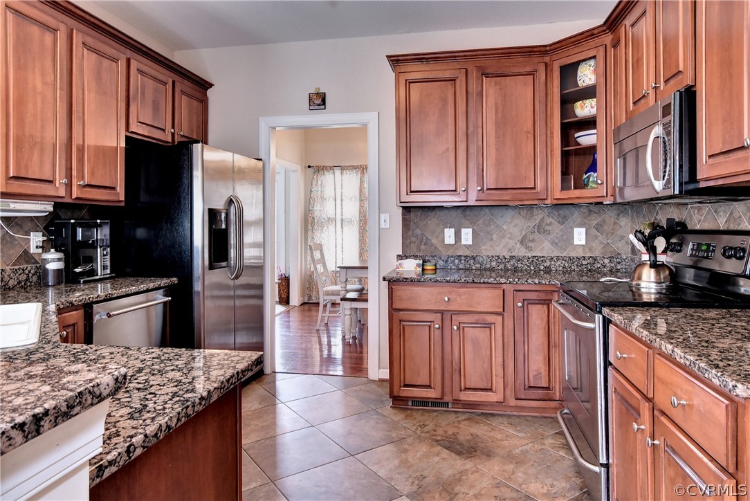 3986 Bournemouth Bend Williamsburg, VA 23188 - Photo 8 of 47 a kitchen with stainless steel appliances granite countertop a stove refrigerator sink and cabinets