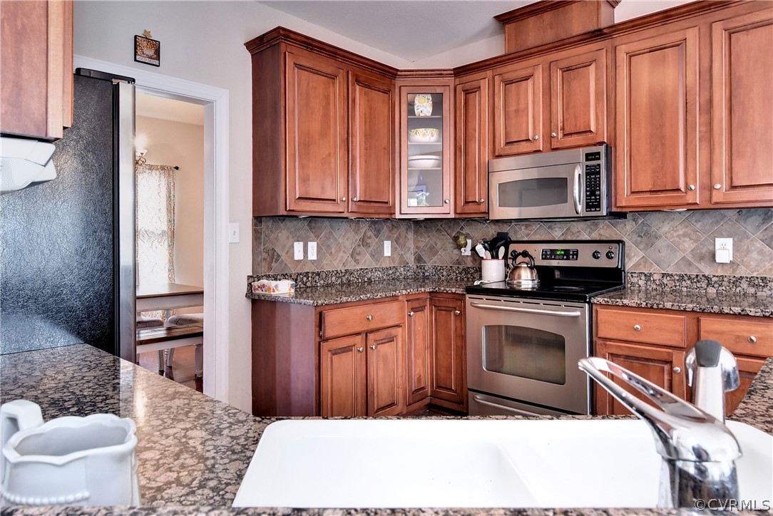 3986 Bournemouth Bend Williamsburg, VA 23188 - Photo 9 of 47 a kitchen with stainless steel appliances granite countertop a stove a sink dishwasher a refrigerator and cabinets