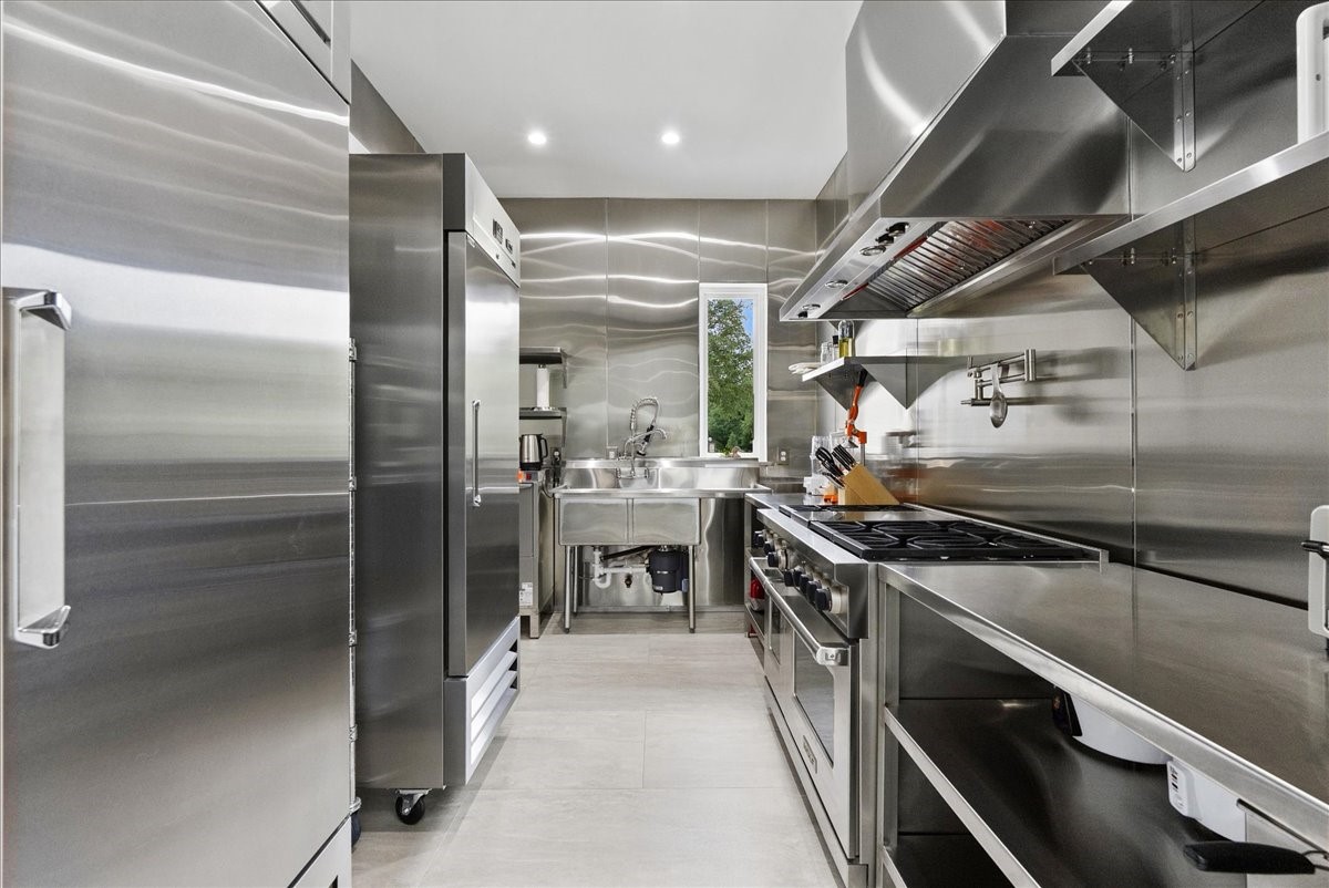 7627 Scott Avenue Manvel, TX 77578 - Photo 21 of 50 This is an absolute rarity in residential real estate! Fully equipped commercial kitchen featuring a dual gas and electric WOLF range.