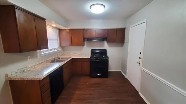 a kitchen with granite countertop a refrigerator and a stove