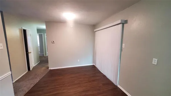 a view of hallway with wooden floor