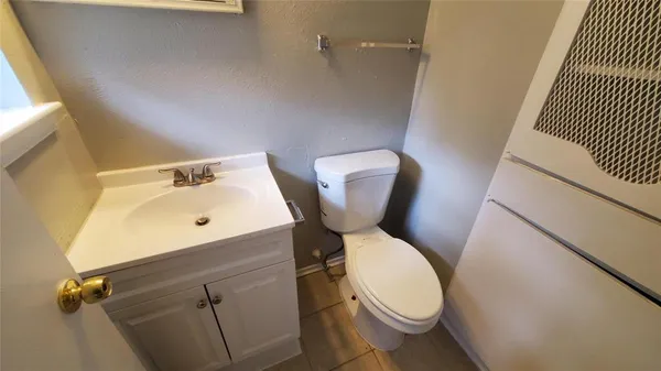 a white toilet sitting next to a bathroom sink