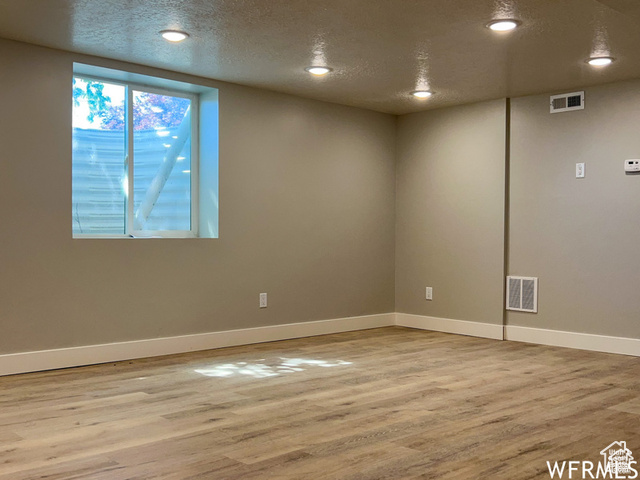 702 North 100 West Logan, UT 84321 - Photo 55 of 58 Interior space featuring baseboards, visible vents, wood finished floors, and a textured ceiling