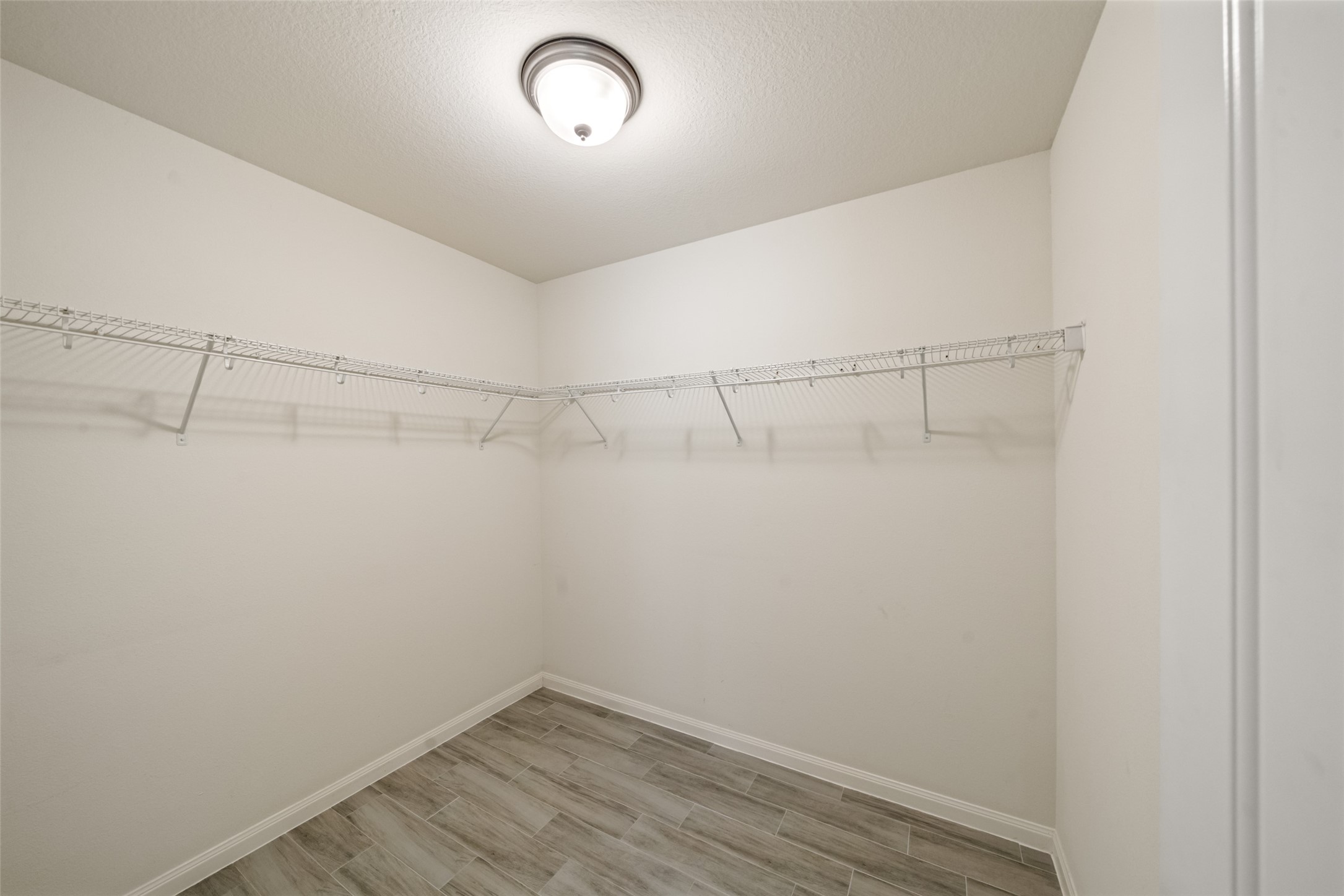9107 Nina Road Conroe, TX 77304 - Photo 18 of 30 Walk-in closet in primary bedroom.