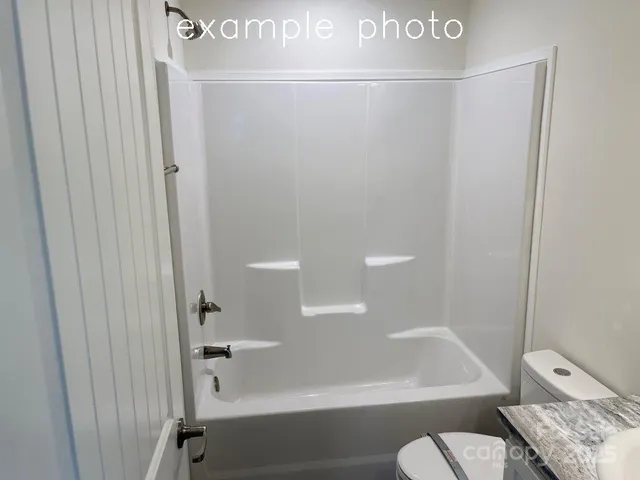 a bathroom with a shower and a toilet