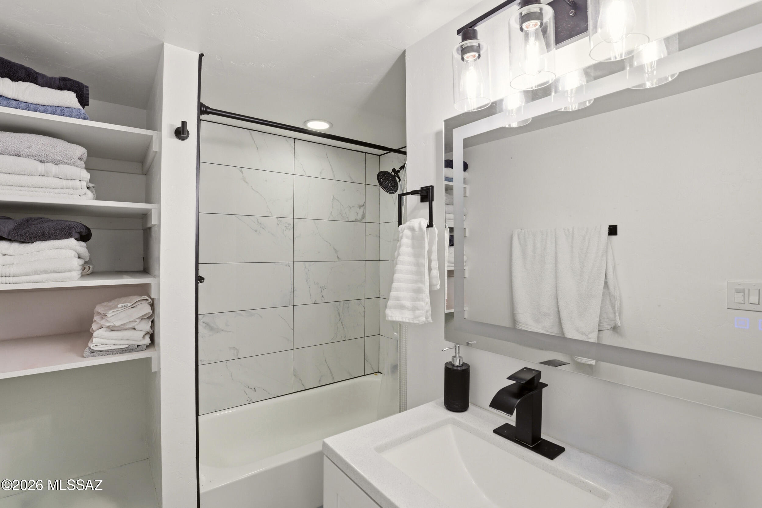 8620 South Sandario Road Tucson, AZ 85736 - Photo 16 of 26 a bathroom with a sink and a shower