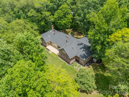 an aerial view of a house with a yard and trees