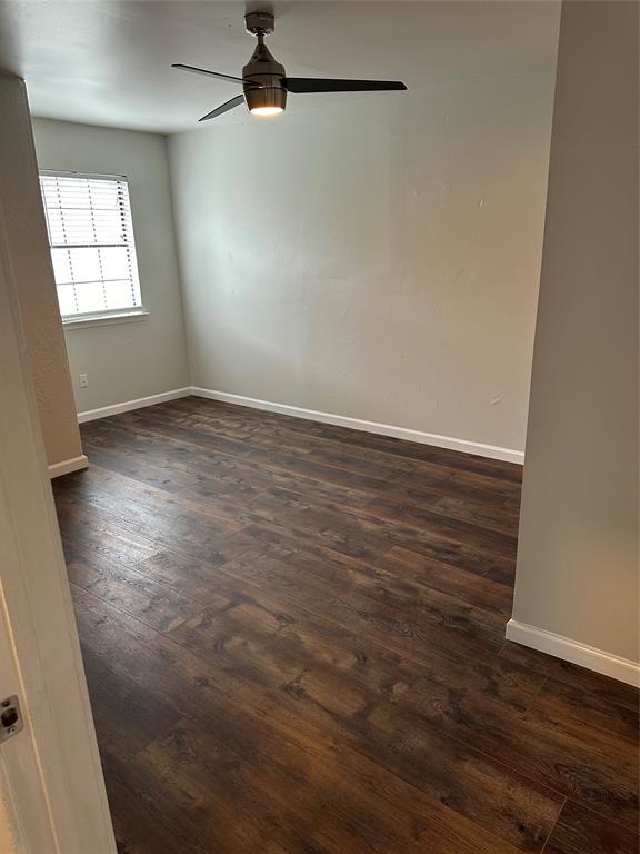 4520 Speedway, Unit A Austin, TX 78751 - Photo 4 of 9 Unfurnished room with dark wood finished floors and a ceiling fan
