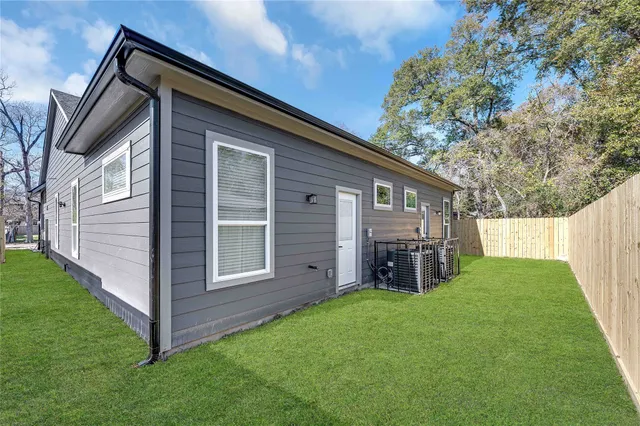 a view of a house with a yard and porch