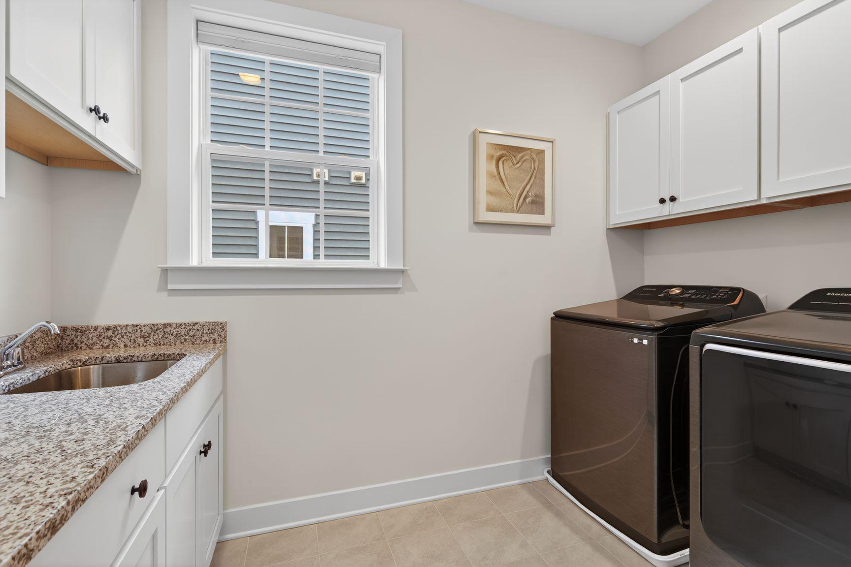 6213 Mcconnell Lane Springfield, VA 22152 - Photo 23 of 39 a kitchen with a granite countertop sink and cabinets